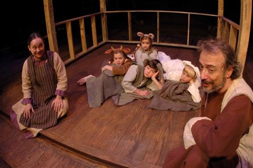 Girl (Amy Thompson) offers her parent's stable to Joseph (far right), which is filled Photo